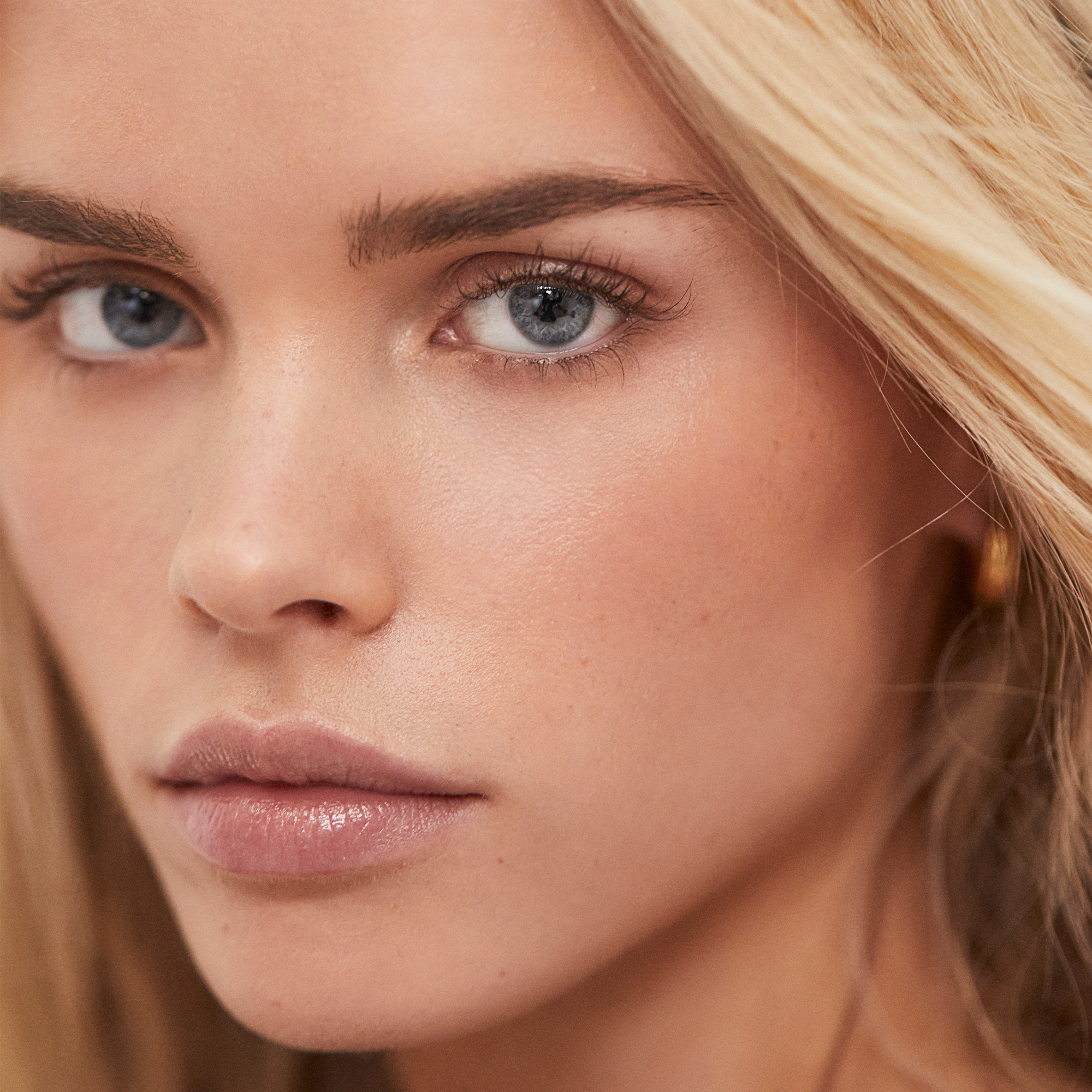 Close up shot of young women with Unique CBD protect serum on face